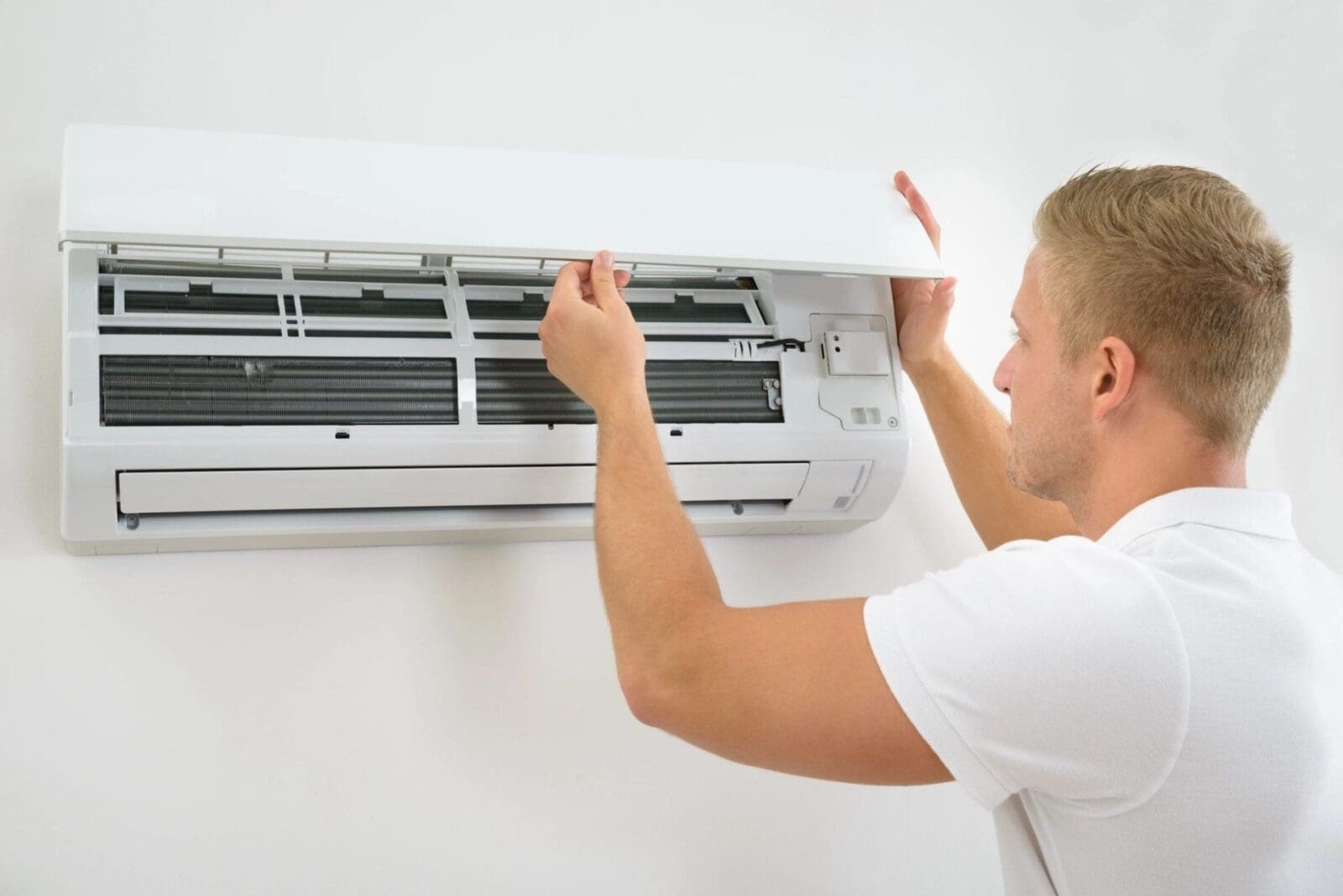 A person holding a split type aircon