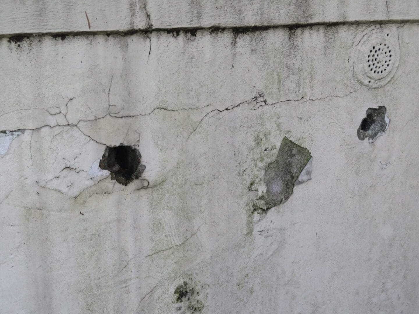 Holes, cracks, and stains on the wall