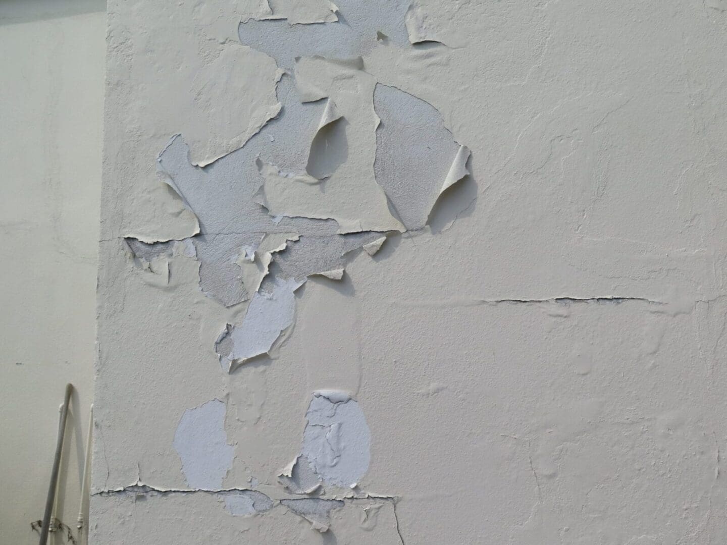 A wall with damaged paint