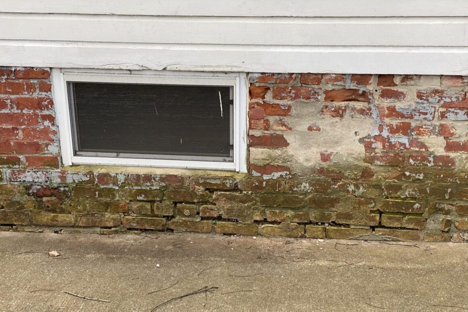 A brick wall with a window on it.