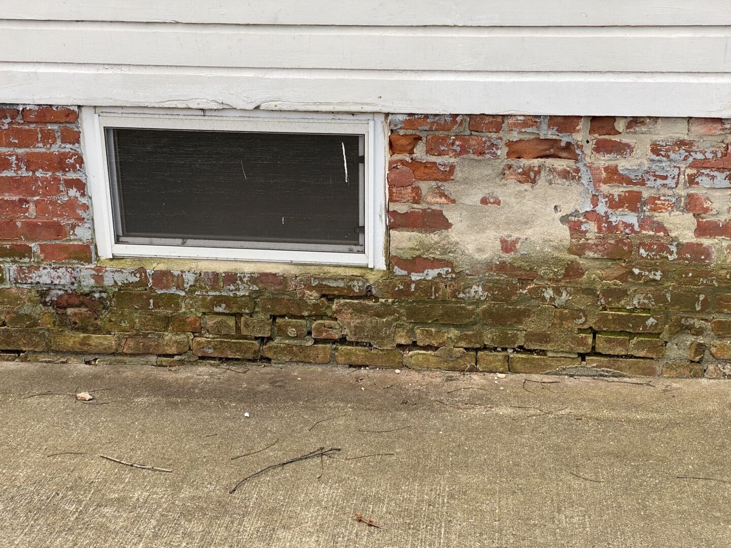A brick wall with a window on it.