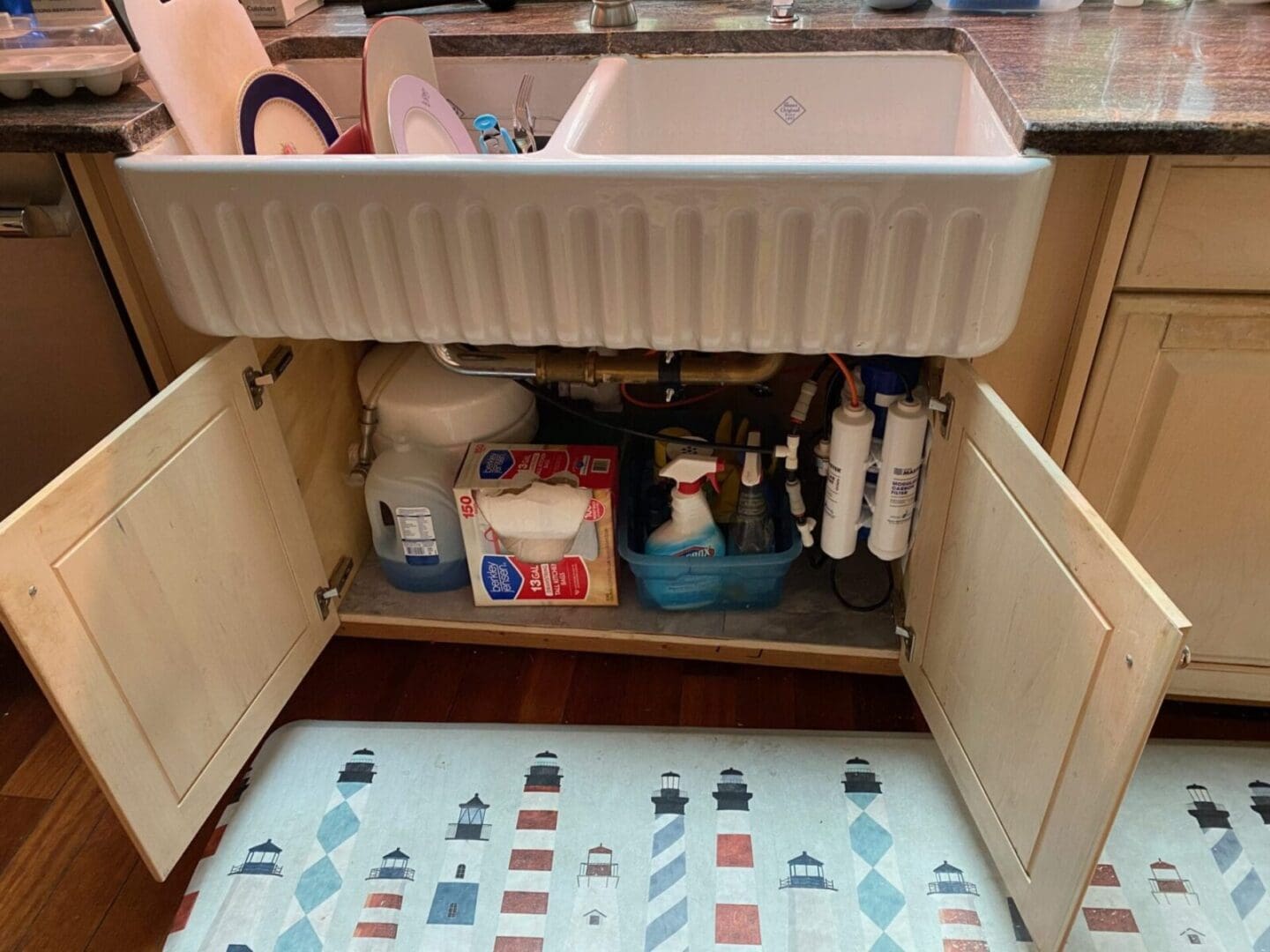 A kitchen with a sink under a rug.