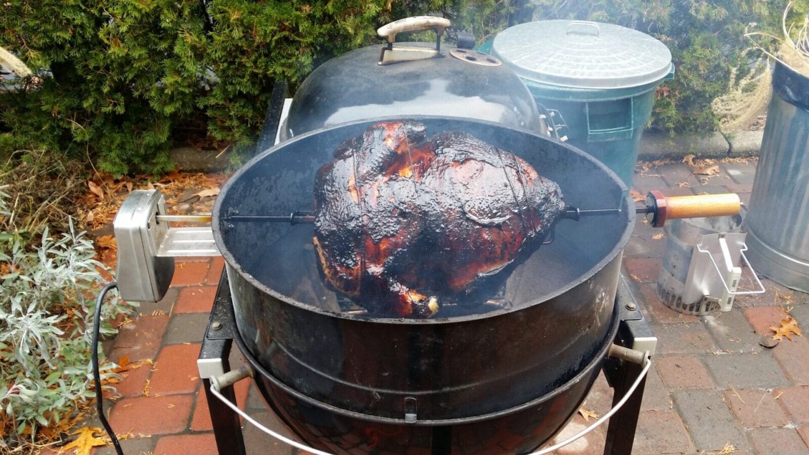 A bbq brisket is being cooked on a bbq grill.