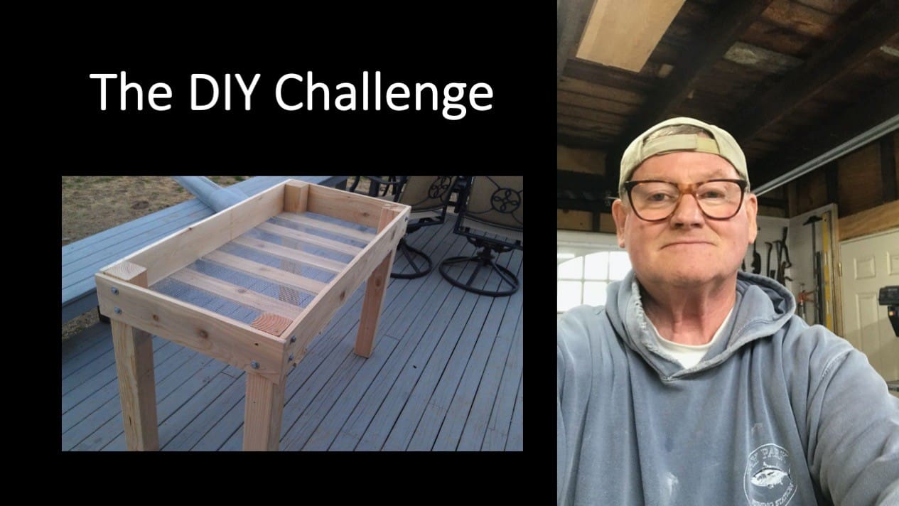 A man is taking a picture of a wooden planter with the words the diy challenge.