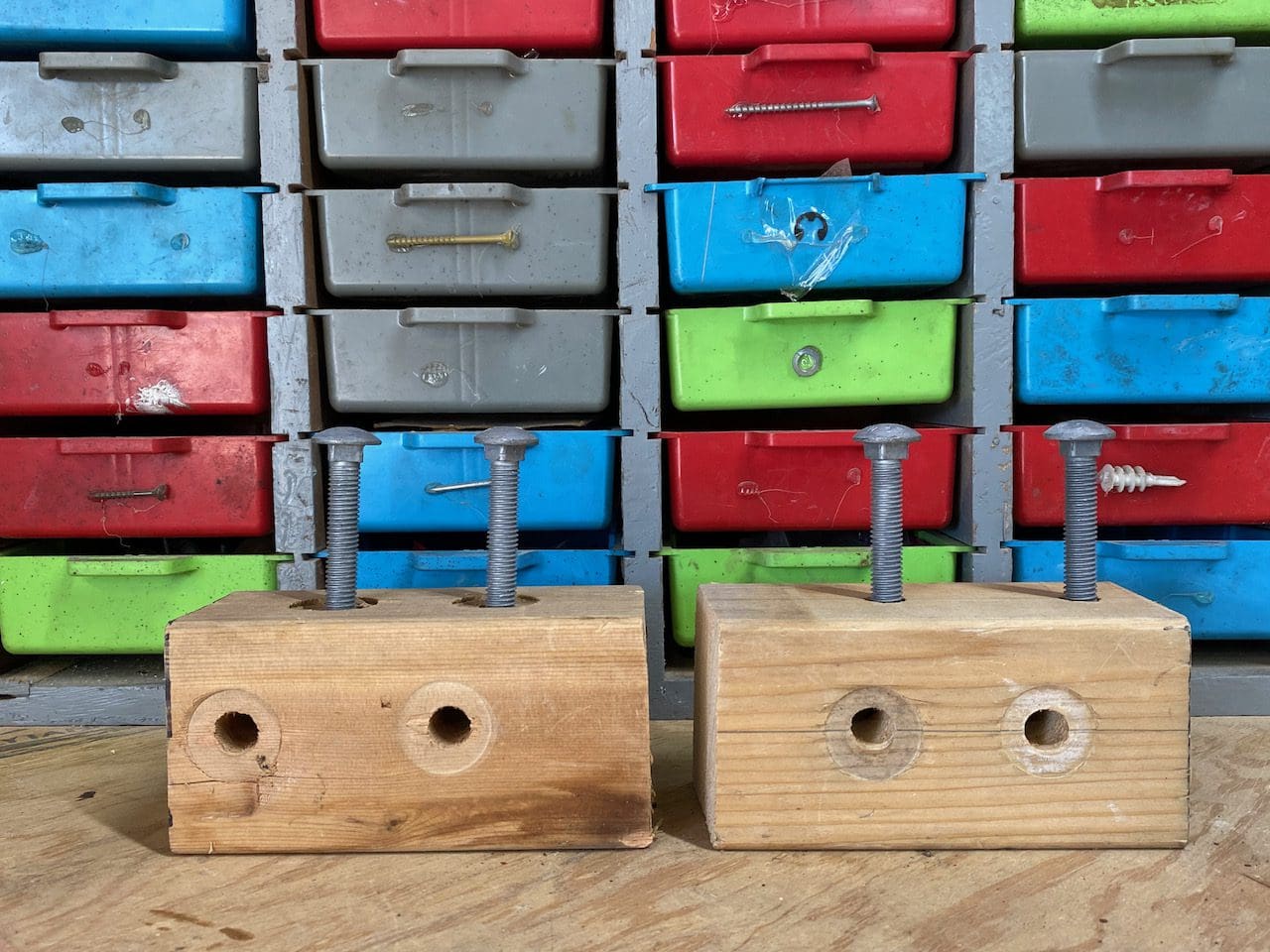 Two wooden blocks with bolts