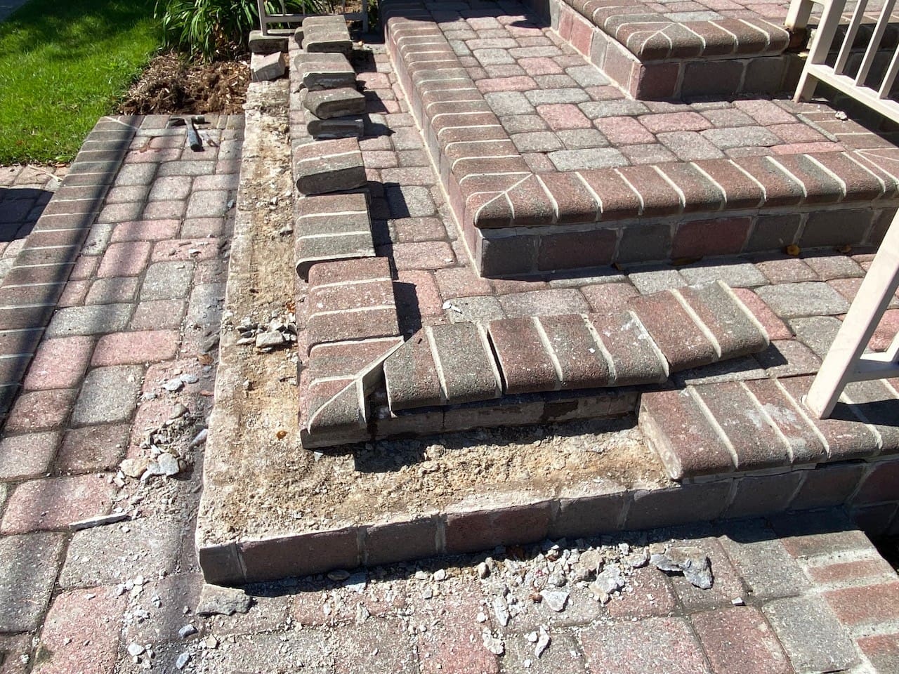 A brick retaining wall is being built in front of a house.